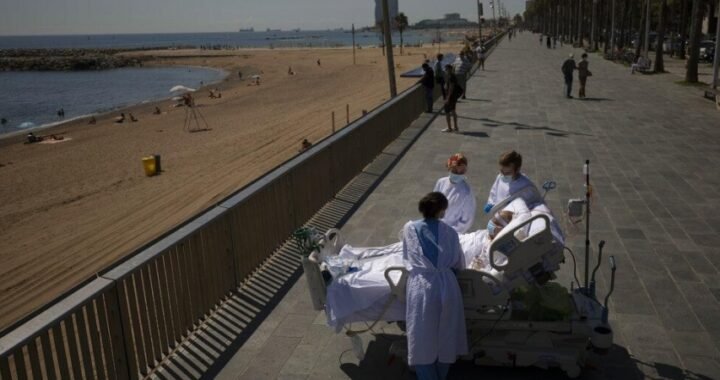 Francisco España, 60, is surrounded by members of his medical team as he looks at the Mediterranean sea from a promenade next to the 'Hospital del Mar' in Barcelona, Spain.