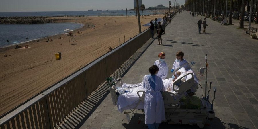Francisco España, 60, is surrounded by members of his medical team as he looks at the Mediterranean sea from a promenade next to the 'Hospital del Mar' in Barcelona, Spain.
