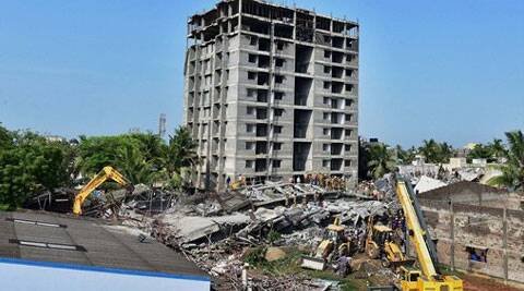 An earthmover clears the debris of the collapsed Tamil Nadu Urban Habitat Development Board building at Tiruvottiyur in Chennai on Monday