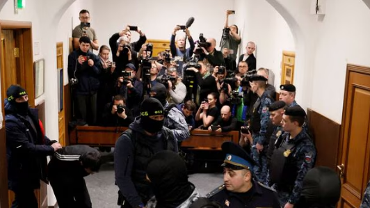 Shamsidin Fariduni, a suspect in the shooting attack at the Crocus City Hall concert venue, is escorted before a court hearing at the Basmanny district court in Moscow, Russia March 24, 2024.